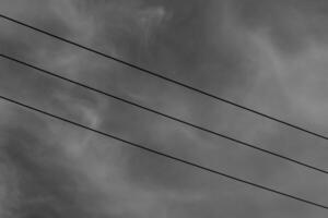 Black and white photography of three parallel electrical cables. Monochrome of exterior on public park. Graphic Resources. Monochrome Background Photography. Light Shadow Photography Concept. photo