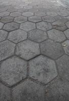 a close-up view of a paved surface made up of hexagonal stone tiles photo
