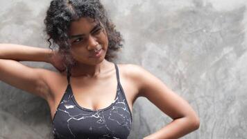 A black woman prepares to exercise outdoors in a park area in the middle of the city. video