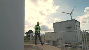 African engineer working in fieldwork. Worker inspect construction and machine around the project site. Wind turbine electrical of clean resource energy and environment sustainable. video