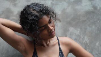 A black woman prepares to exercise outdoors in a park area in the middle of the city. video