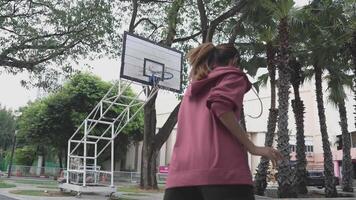Men and women play basketball alone in public areas for fun and practice at the same time. video