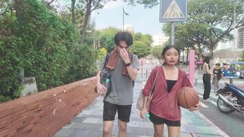 Men and women play basketball alone in public areas for fun and practice at the same time. video