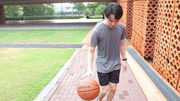 A man plays basketball alone in a public area, having fun and practicing at the same time. video