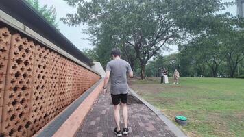 A man plays basketball alone in a public area, having fun and practicing at the same time. video