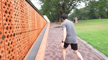 A man plays basketball alone in a public area, having fun and practicing at the same time. video