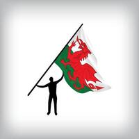 A man holds the flag of WALES in the air. flag waving. National day realistic flag vector