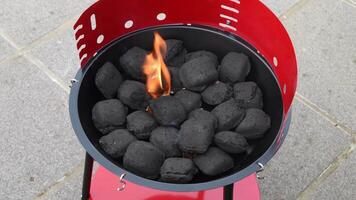 igniting pressed coal for barbecue in a portable grill using a special combustible material video
