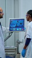 Team of multiethnic scientists working in laboratory analysing test trial vaccine checking drug data in pc. Diverse group of scientists examining virus evolution using high tech for research photo