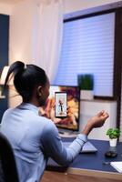 Dark skinned sick woman discussing with medical physician in the course of online consultation. Black patient in a call with medic discussing health problems of woman. photo