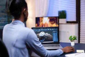 Dark skinned woman working on mechanical concept late at night from home office. Industrial black female engineer studying prototype idea on personal computer showing software on device display photo