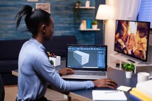 African american remote woman architect working on modern cad program overtime. Industrial black female engineer studying prototype idea on personal computer showing software on device display photo
