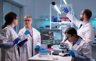 Woman tehnician lab doctor in white coat looking under microscope analysing various bacteria in laboratory. Research chemists working in lab with high tech examining genetic material samples photo
