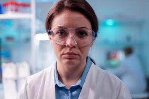 Close up portrait of scientific specialist health care in laboratory. Researcher in biology medicine lab working with professional technology equipment for pharmaceutical development. photo