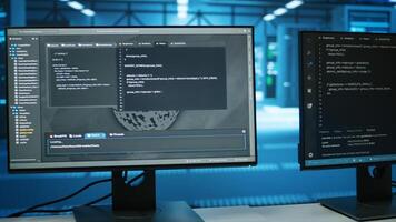 Computers in empty data center facility managing rackmounts energy consumption. Close up of script on PC monitors used for automation and monitoring processes in server room, camera A photo
