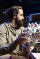 Computer scientist using EEG headset to upload his mind into computer, attaining immortality. Software developer in apartment experimenting with transferring consciousness into cyberspace photo