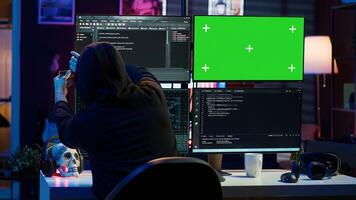Cybercriminal uploading USB flash drive containing stolen information into green screen computer. Scammer inserting storage device into chroma key PC with data obtained from security breach, camera A photo