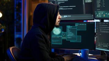 Hacker using PC to steal data, targeting unpatched security systems using malware. Scammer using computer to compromise digital devices, writing rogue script attacking firewalls, camera A photo