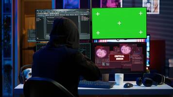 Rogue programmer using green screen PC to hack firewalls, getting attacks rejected by cybersecurity. Scammer using mockup monitor seeing access denied error message while committing fraud, camera A photo