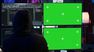 Dangerous man hacking using isolated screen PC, stealing credit card information and breaching banking systems. Hacker running code in apartment on chroma key computer display, close up, camera A photo