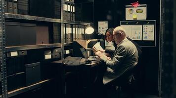 Inspectors team reviewing case information and reading witness statements to create a profile for the suspect. Detectives look into forensic evidence in police archive room, criminology. Camera B. photo