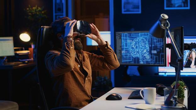 Computer scientist wearing VR glasses panicking after AI gains omniscience, throwing goggles and programming firewall. Programmer afraid by artificial intelligence gaining enlightenment, camera A photo