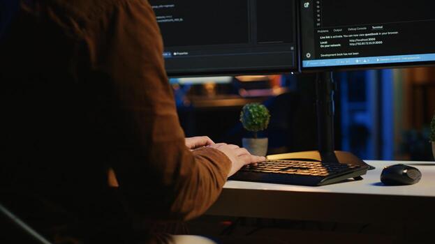 Angry programmer impatiently spamming broken keyboard buttons, trying to type lines of code in apartment office. Annoyed IT admin having difficulties with damaged computer peripheral, close up photo