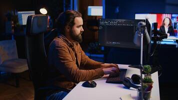 Computer engineer deliberating ways of fixing errors while developing code on PC. IT professional brainstorming ways of solving database errors, remotely working from home, camera B photo