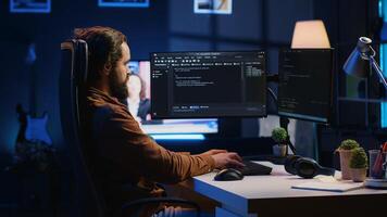 Experienced programmer writing code on computer screen while in office using java programming languages. Developer working on fixing database errors while working from home, camera A photo