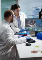 Scientist team discussing coronavirus discovery analyzing biomedical expertise developing virus vaccine during medical experiment. Biologists working in hospital laboratory. Treatment investigation photo