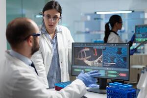 Scientist team discussing coronavirus discovery analyzing biomedical expertise developing virus vaccine during medical experiment. Biologists working in hospital laboratory. Treatment investigation photo