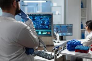 Biologist researcher analyzing virus expertise working at sickness prevention treatment during biochemistry medical investigation. Scientist using biotechnology for examination in biomedical lab photo