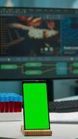 Display phone with green screen, mock up on template placed on desk in scientific lab while team of medical researcher scientists analysing virus evolution at digital monitor conducting experiment photo