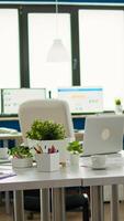 Interior of cozy light company room with conference table ready for brainstorming, modern stylish chairs and desktop monitor, all ready for employees. Empty spacious office of creative working space. photo