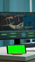 Scientist standing at monitor in background analysing virus evolution while phone with mock-up green screen working in front. Woman lab researcher examining vaccine developent bringing blood samples photo