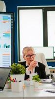 Group of diverse business people discussing with partners on call during meeting sitting in conference room. Internet conference call technology talk with investors, corporate brainstorming via web photo