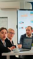 Pov of diverse team sitting in conference room during virtual meeting, discussing online with business partners. Internet conference call technology talk with investors, corporate brainstorming via web photo