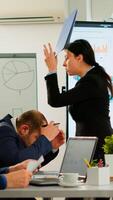 Angry manager woman arguing disagreeing about bad business contract, diverse colleagues having conflict dispute about document sitting in office desk during brainstorming partners working in boardroom photo