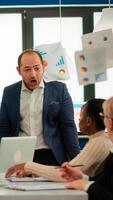 Nervous businessman quarrelling in coworking having conflict at workplace blaming accuses for bad work incompetence mistakes. Reprimanding unsuccessful results and rivalry concept. photo