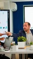 Diverse businesspeople discussing company strategy, project manager giving tasks to employee. Company leader talking with teamworkers in meeting broadroom, group negotiations speaking with clients photo