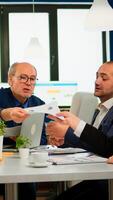 Smart team of multiethnic people using documents in planning for meeting, secretary female bring documents to boss during conference. Manager briefing diverse teamworkers during brainstorming. photo
