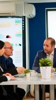 Young man company leader waiting diverse team for business conference meeting sitting in broadroom at table. Executive director briefing multiethnical people, explaining start up financial reports photo