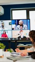 Headshot screen application view of remote multiracial employees talking on call brainstorm together multiethnic coworkers engaged in team discussion online using web conference, virtual meeting photo