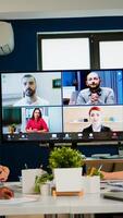 Team working by group call share ideas brainstorming negotiating use conference, pc screen view multi ethnic young people. Diverse people talking at virtual meeting, online discussion. photo