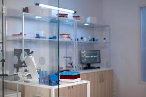 Empty medical neuroscience laboratory with nobody in it with professional equipment ready for neurological experiment. Lab with brain scan on monitor. Medicine industry with high tech facility photo