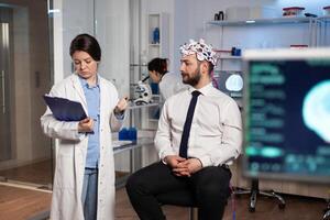 Specialist neurologist researcher monitoring brain evolution developing treatment for neurological disease in modern laboratory. Scientist doctor analyzing nervous system activity. Neurology service photo