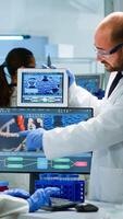Chemists worried about virus evolution comparing DNA informations from tablet discussing in laboratory. Stuff examining vaccine development using high tech researching treatment against covid19 virus photo