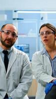 Team of researchers looking at virtual display with touchscreen, virtual reality using medical inovation in lab, gesticulating. Scientists working with equipment device, future, healthcare, vision, simulator photo