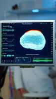 Neurologist doctor analysing nervous system using eeg headset scanning woman brain. Scientist researcher using high tech developing neurological innovation, monitoring side effects on monitor screen photo
