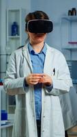 Laboratory doctor experiencing virtual reality using vr goggles in medical neurological research lab. Physician therapist using medical innovation equipment device glasses, analysing brain scan photo